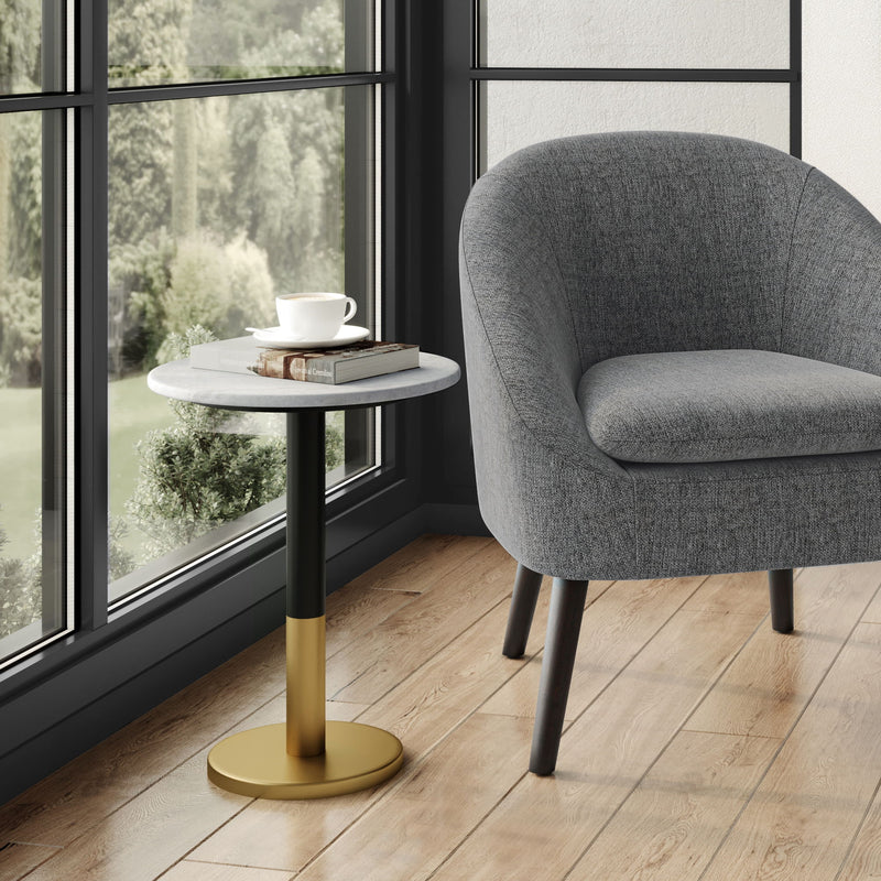 Round side table with a white marble-look top, black stem, and gold-tone base.