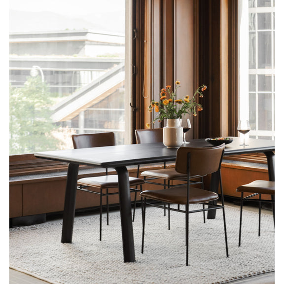 Brown dining chair with curved back, padded seat, and black metal frame