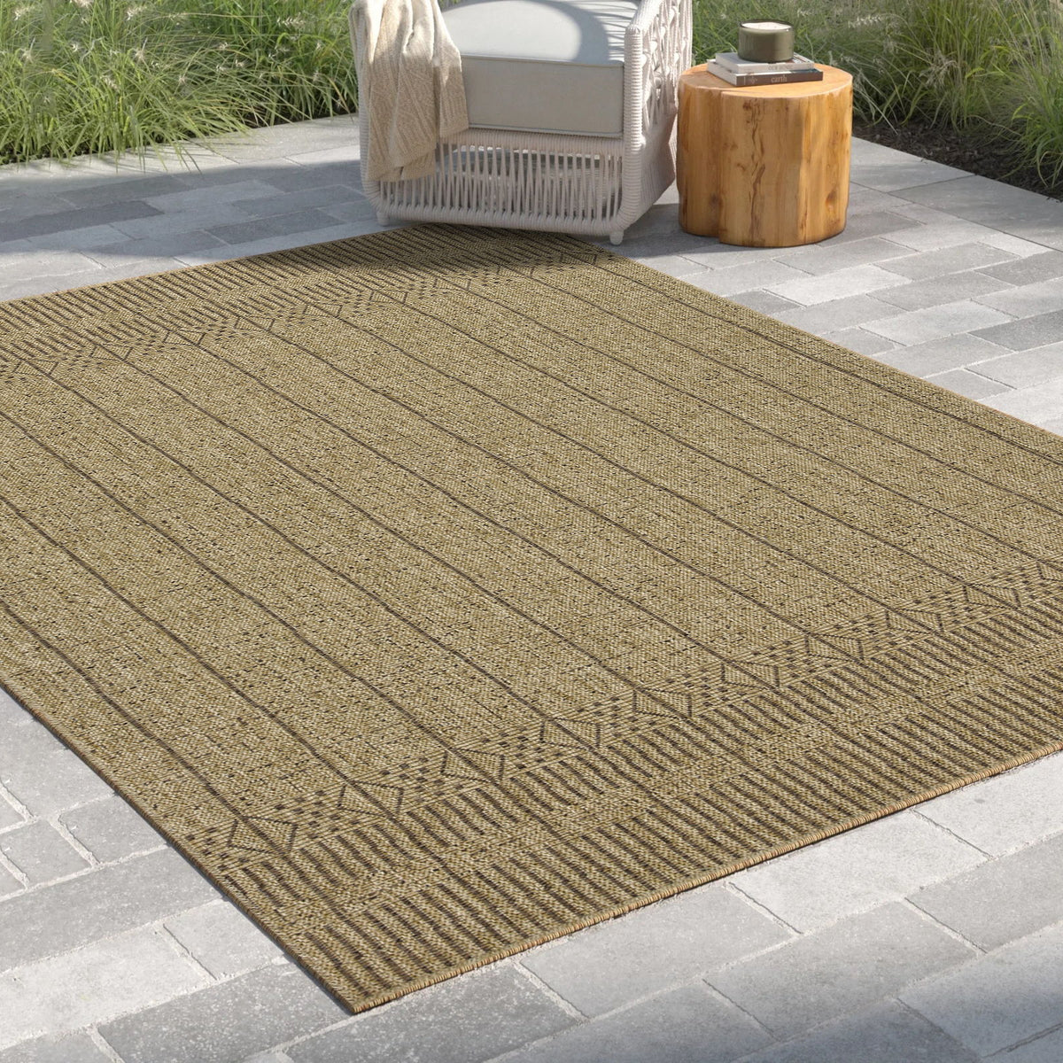 Rectangular light brown area rug with vertical lines and repeating geometric border.
