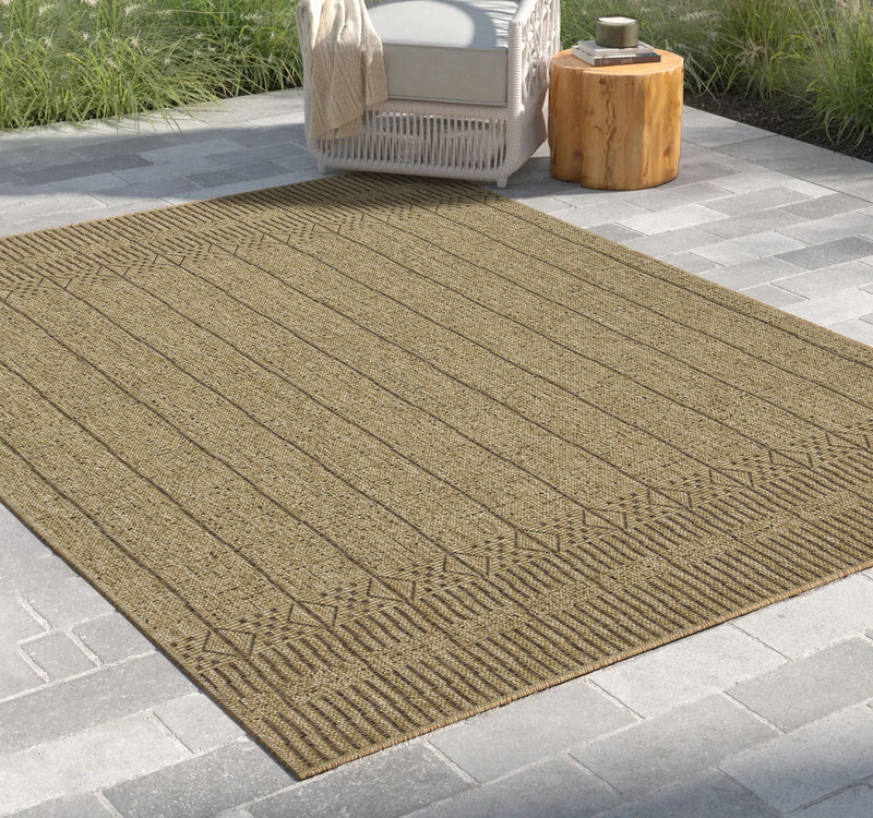 Rectangular light brown area rug with vertical lines and repeating geometric border.