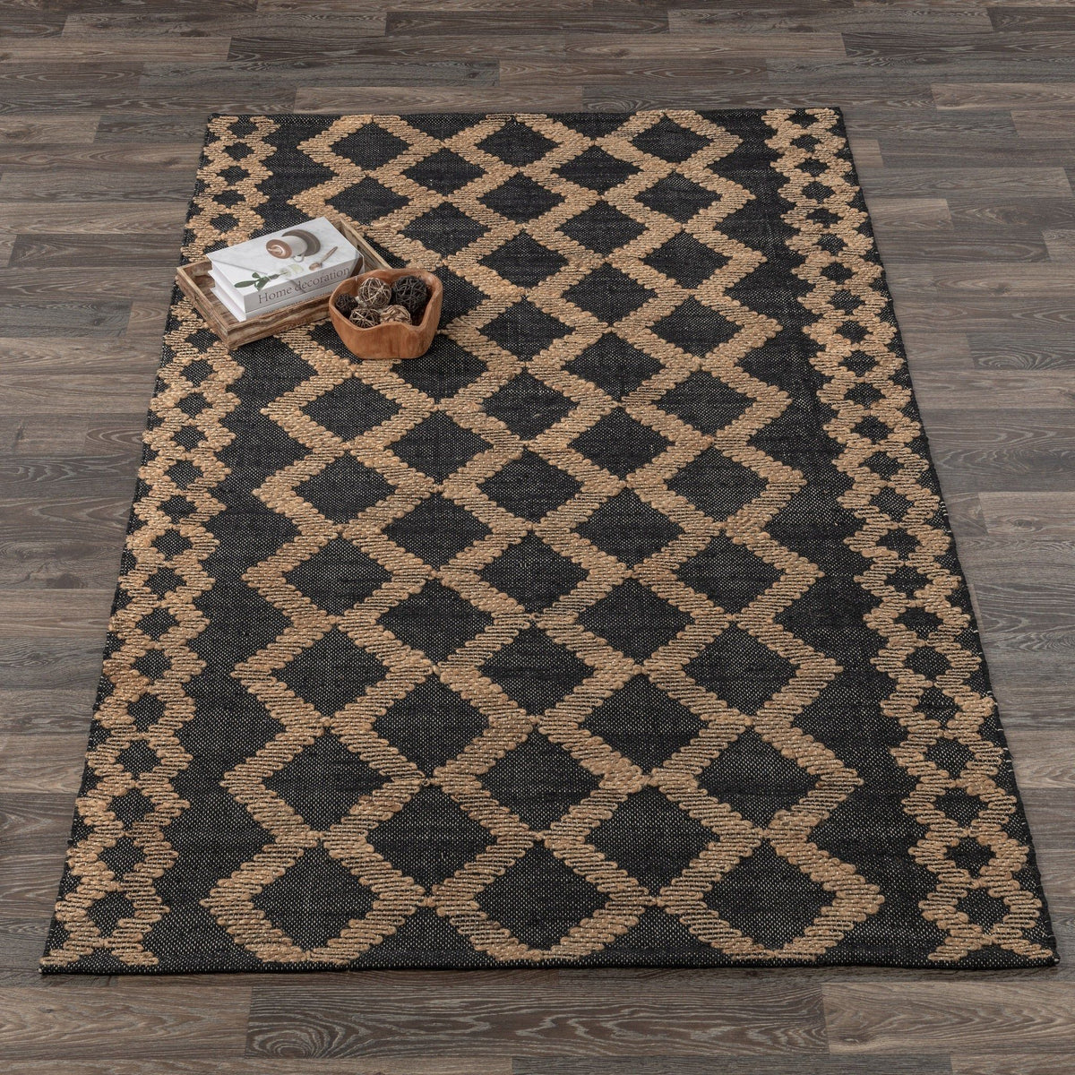 Geometric diamond-pattern rug in black and natural, with textured woven details