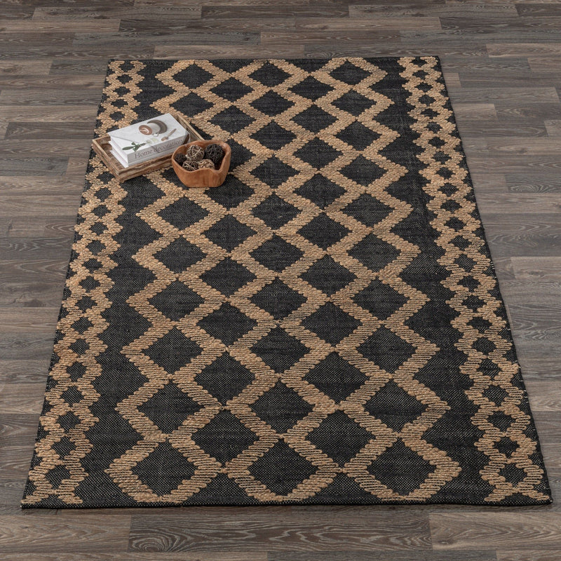 Geometric diamond-pattern rug in black and natural, with textured woven details