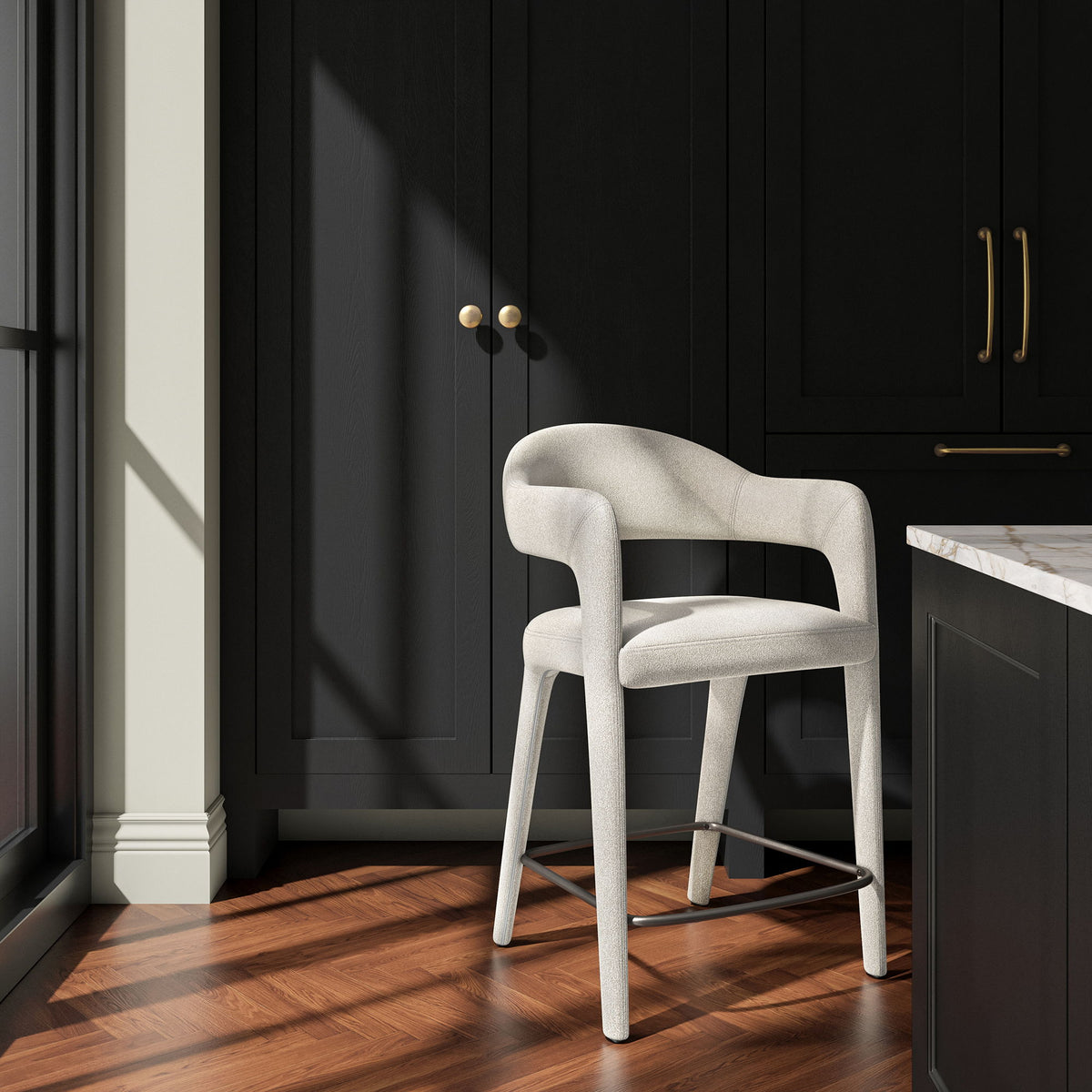 Beige upholstered counter stool with curved arms and a metal footrest, shown at an angle