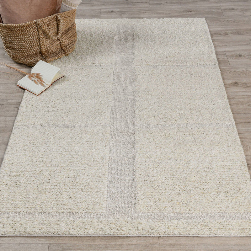 Ivory wool area rug with textured weave, tonal blocks, and a vertical panel