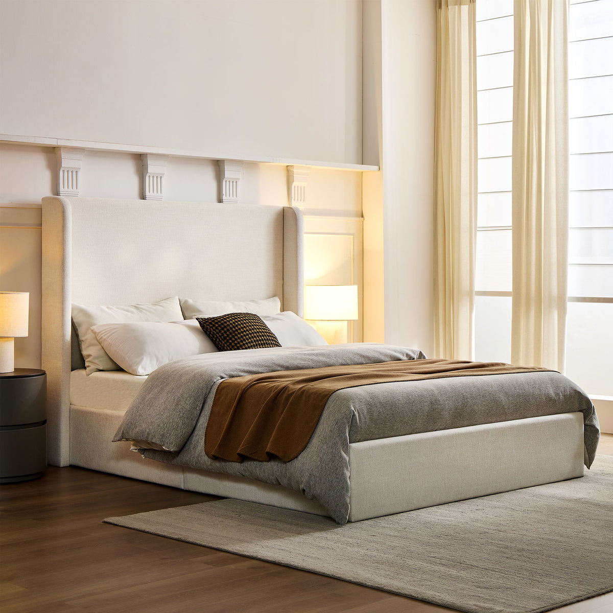 Ivory upholstered king bed with a high wingback headboard, dressed with bedding