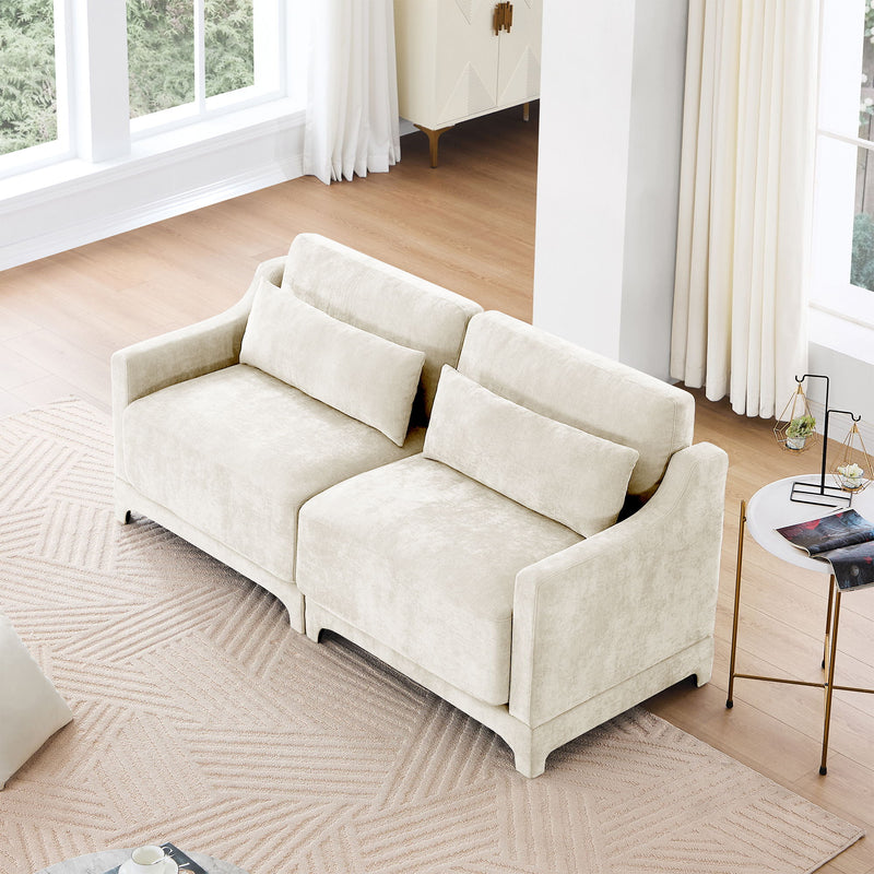 Light beige sofa with two lumbar pillows, boxy cushions, and low wooden legs