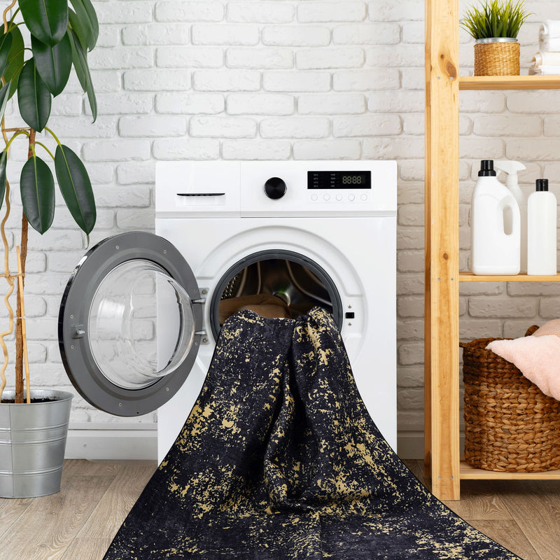 Washable dark navy runner rug with yellow speckle pattern covering the washer opening.