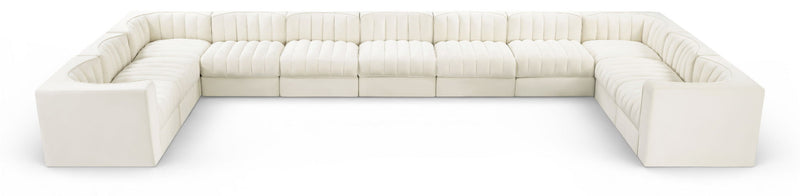 White modular sectional sofa with velvet-look upholstery and tufted cushions