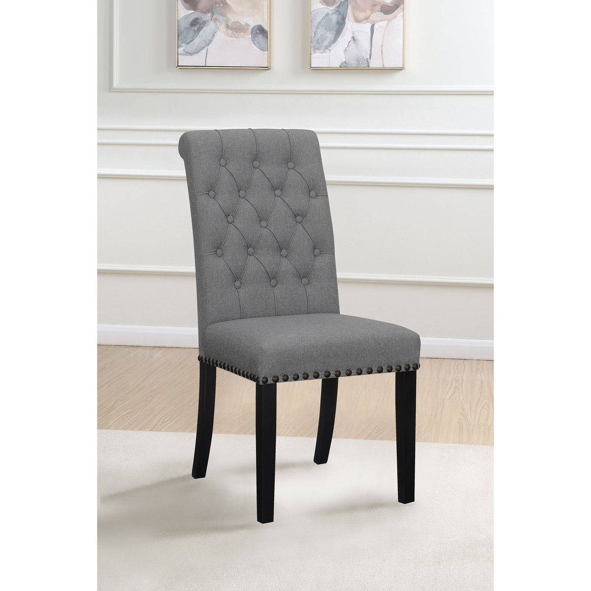 Dark gray tufted rolled backrest side chair with nailhead trim and dark wooden legs