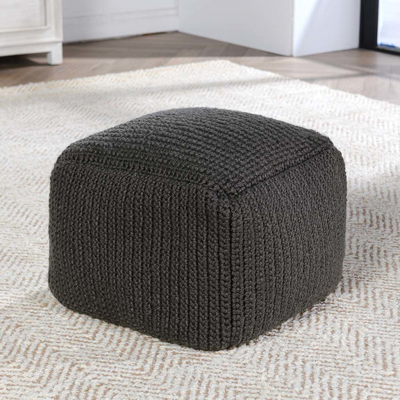Dark gray knitted pouf with ribbed texture and squared rounded sides