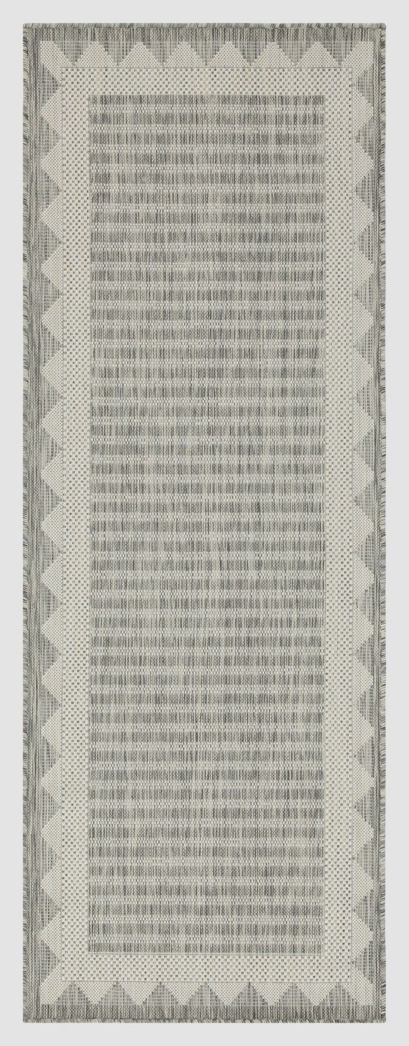Light gray striped area rug with subtle chevron border and narrow vertical stripes