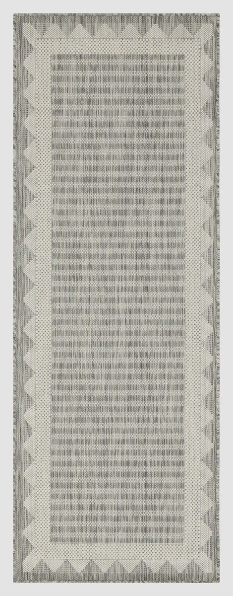 Silver-gray rug with textured stripe pattern and zigzag border.