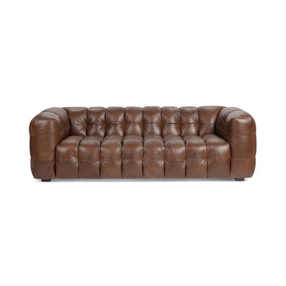 Chestnut-brown tufted leather sofa with rolled arms and square legs.