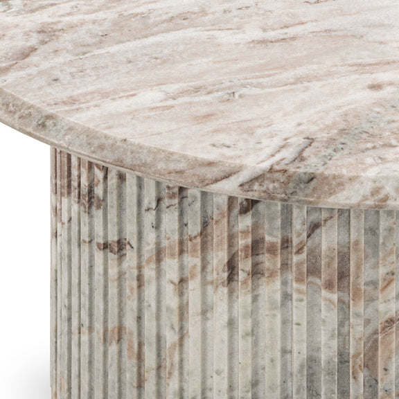 Marble table corner showing veined top and vertical striped cylindrical sides