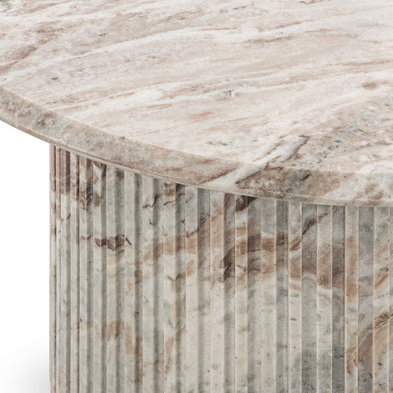 Marble table corner showing veined top and vertical striped cylindrical sides