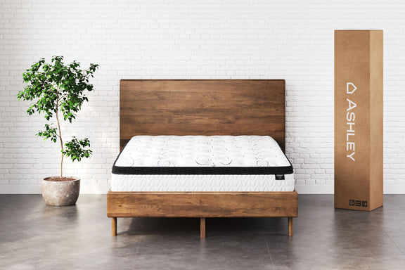White 12-inch hybrid mattress on wooden bed frame, quilted top with black edge