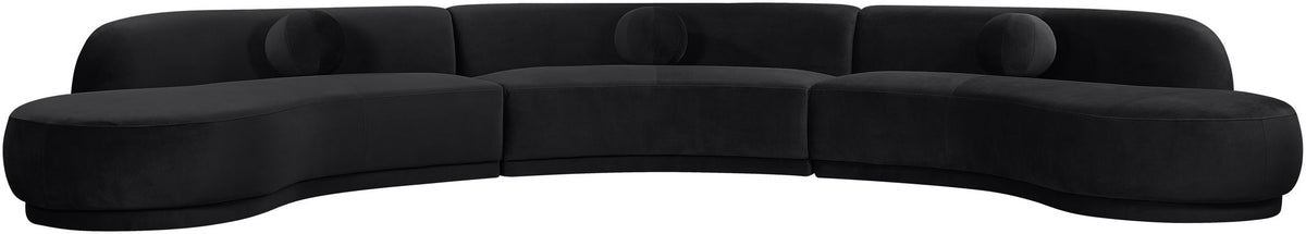 Black velvet upholstered sectional with curved chaise and plush round seat cushions