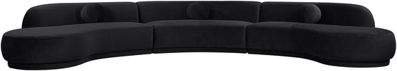 Black velvet upholstered sectional with curved chaise and plush round seat cushions