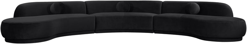 Black velvet upholstered sectional with curved chaise and plush round seat cushions