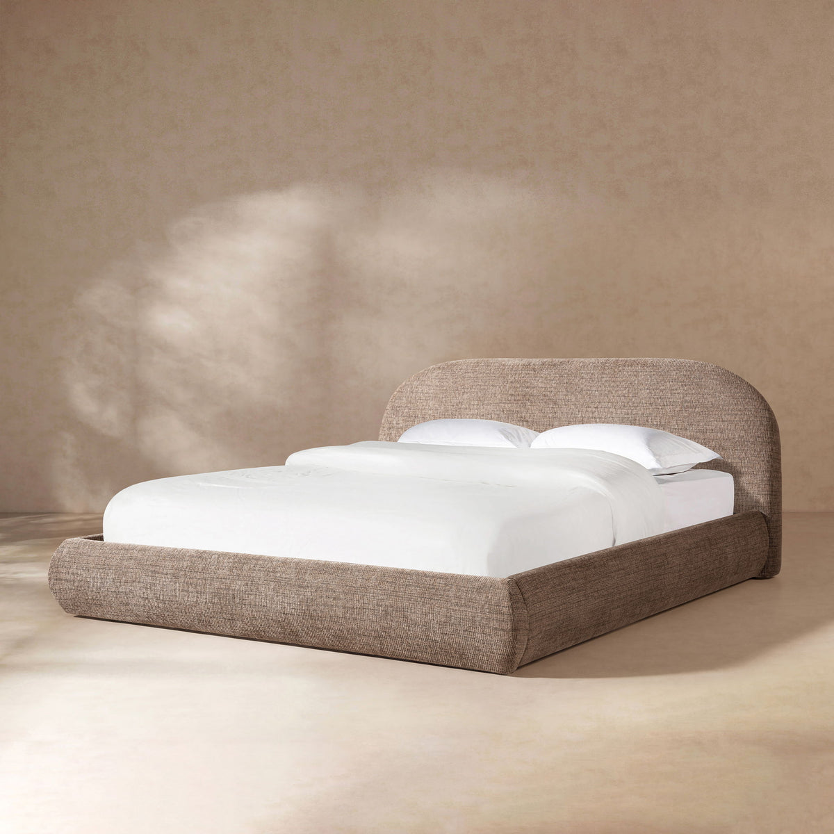 Upholstered platform bed in dark brown fabric with padded headboard and slat support