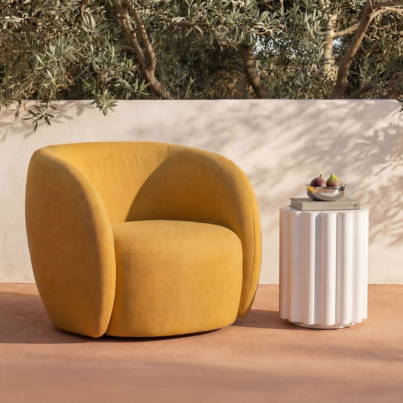 Yellow-orange outdoor accent chair with curved arms and thick seat cushion