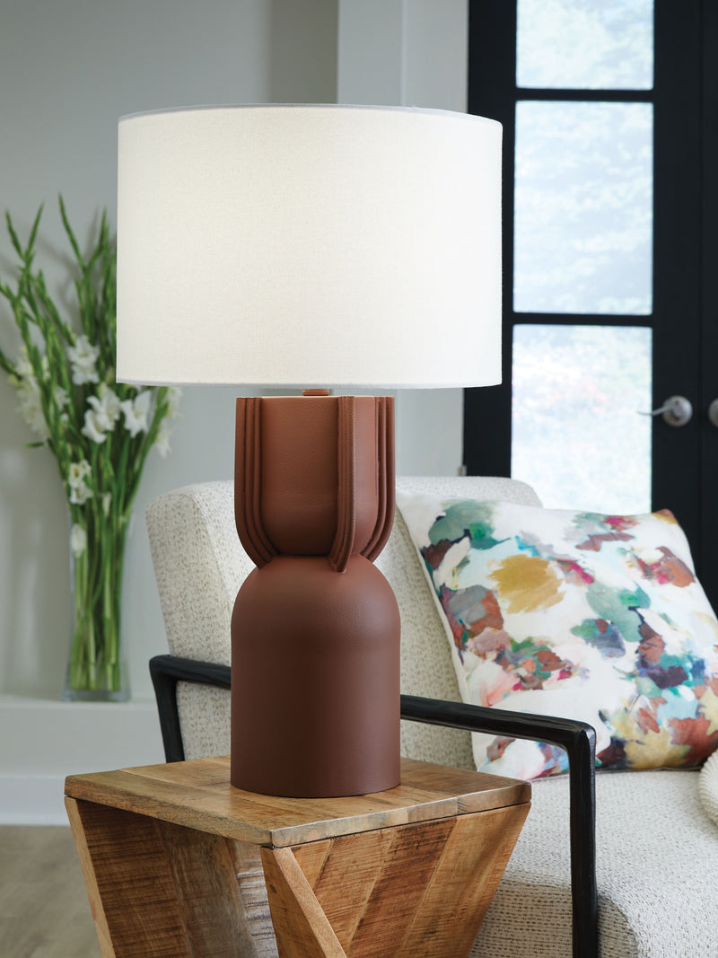 Brick red metal table lamp with white drum shade and ribbed midsection