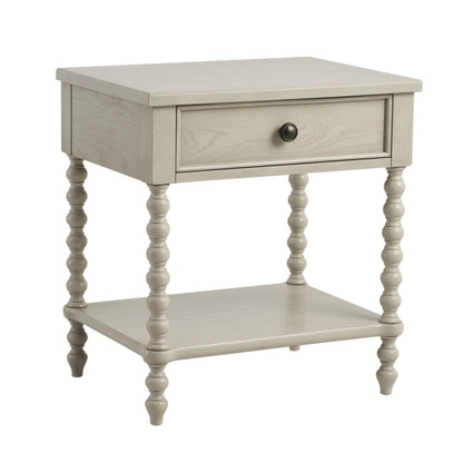 Beige nightstand table with one drawer, lower shelf, and turned legs