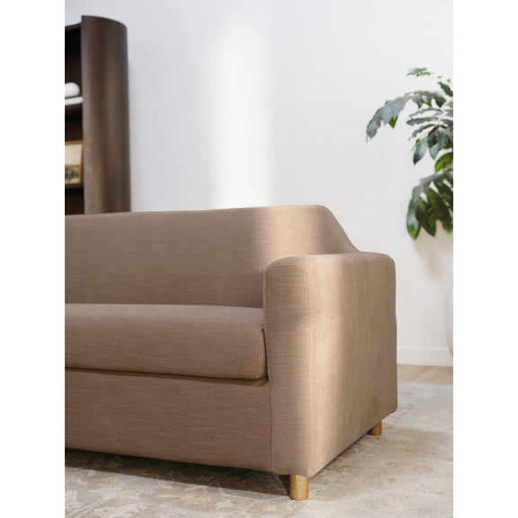 Soft brown upholstered sofa with rounded arms, thick back, and wooden feet.