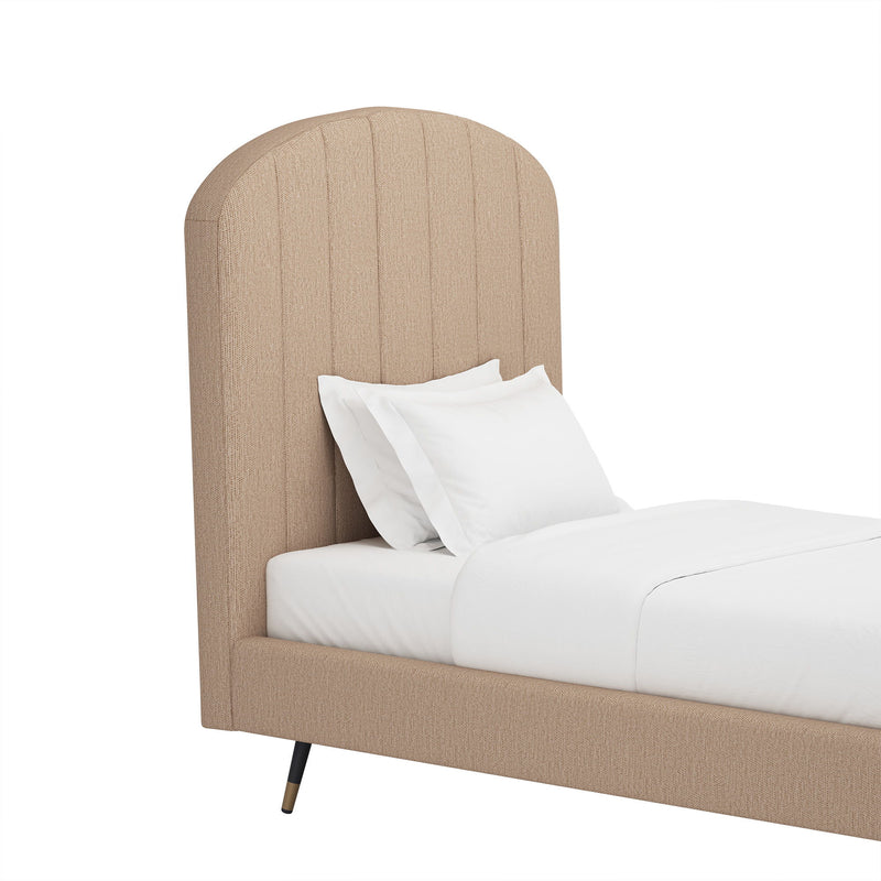 Light brown upholstered bed with arched channel headboard and white pillows