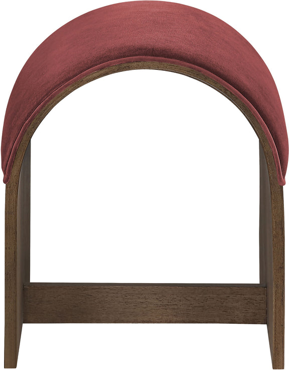 Dark red velvet upholstered bench end with arched top and dark wood frame