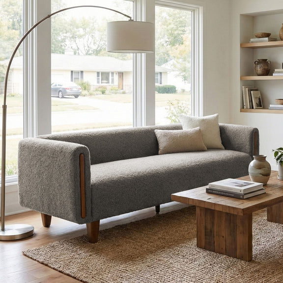 Dark gray 3-seater sofa with armrests, fabric upholstery in a bright living room
