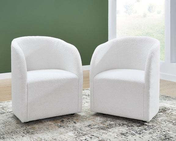 Set of 2 ivory upholstered dining armchairs with curved arms, padded seats, and dark feet