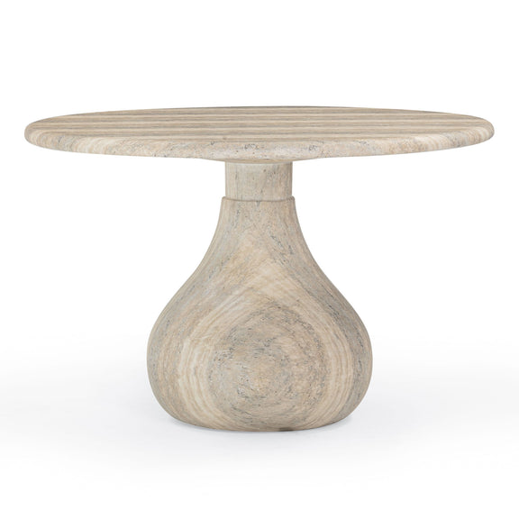 Light brown round dining table with speckled marble-look top and pedestal base