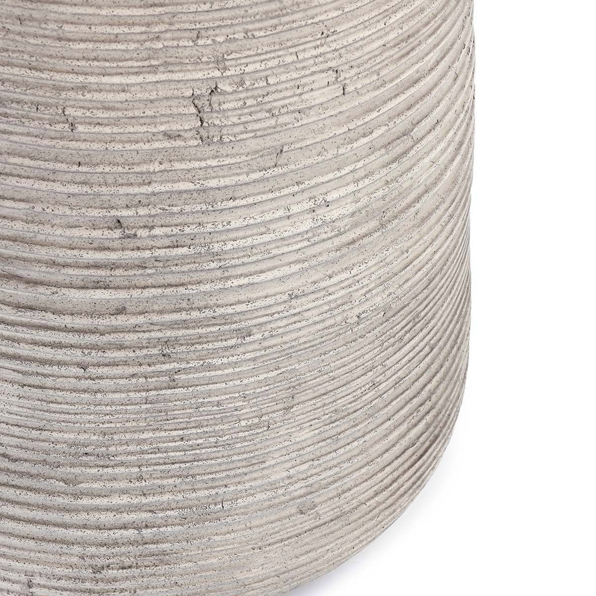 Gray outdoor table side close-up with stacked ribbed texture and small scuffs