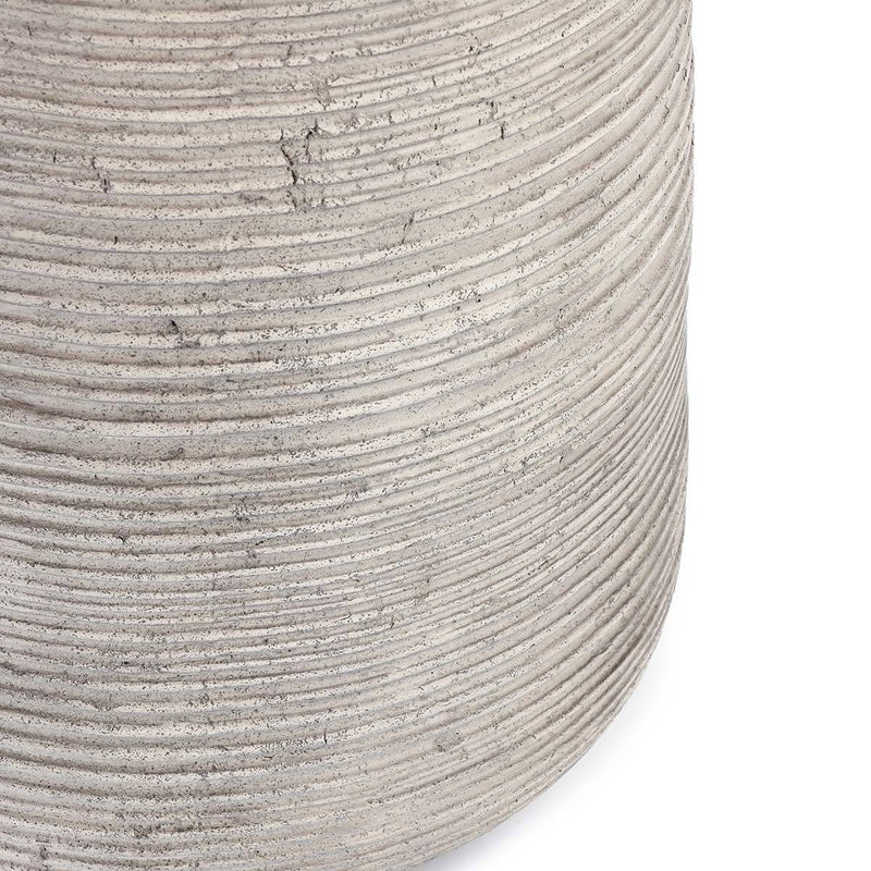 Gray outdoor table side close-up with stacked ribbed texture and small scuffs