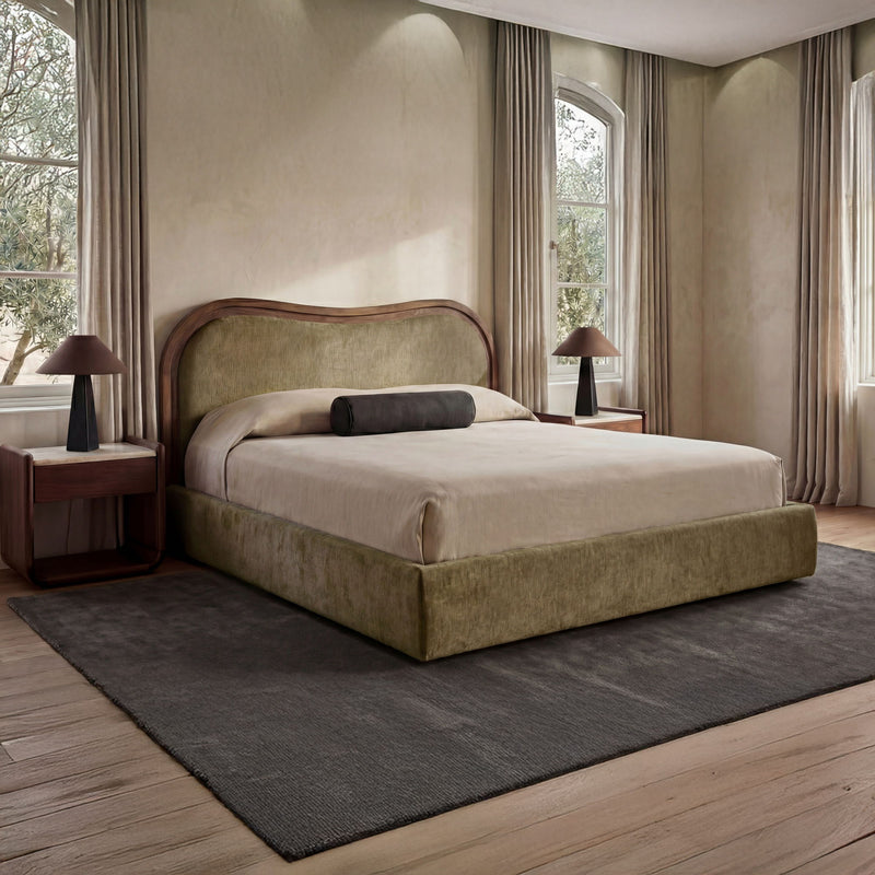 Upholstered king bed with curved headboard, green fabric, and matching platform base