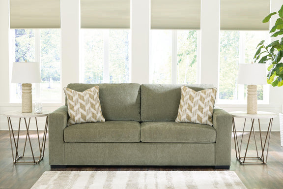 Bridgepoint sofa in green fabric with two seat cushions and two patterned throw pillows