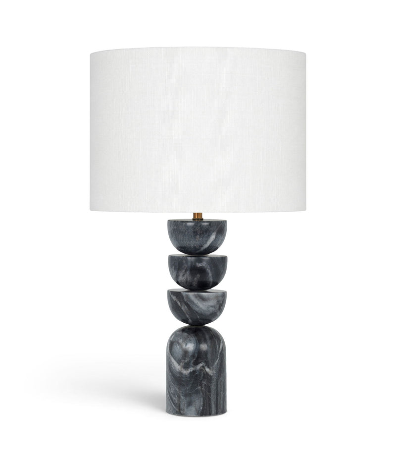 Table lamp with stacked dark marble base and white fabric drum shade, brass accents