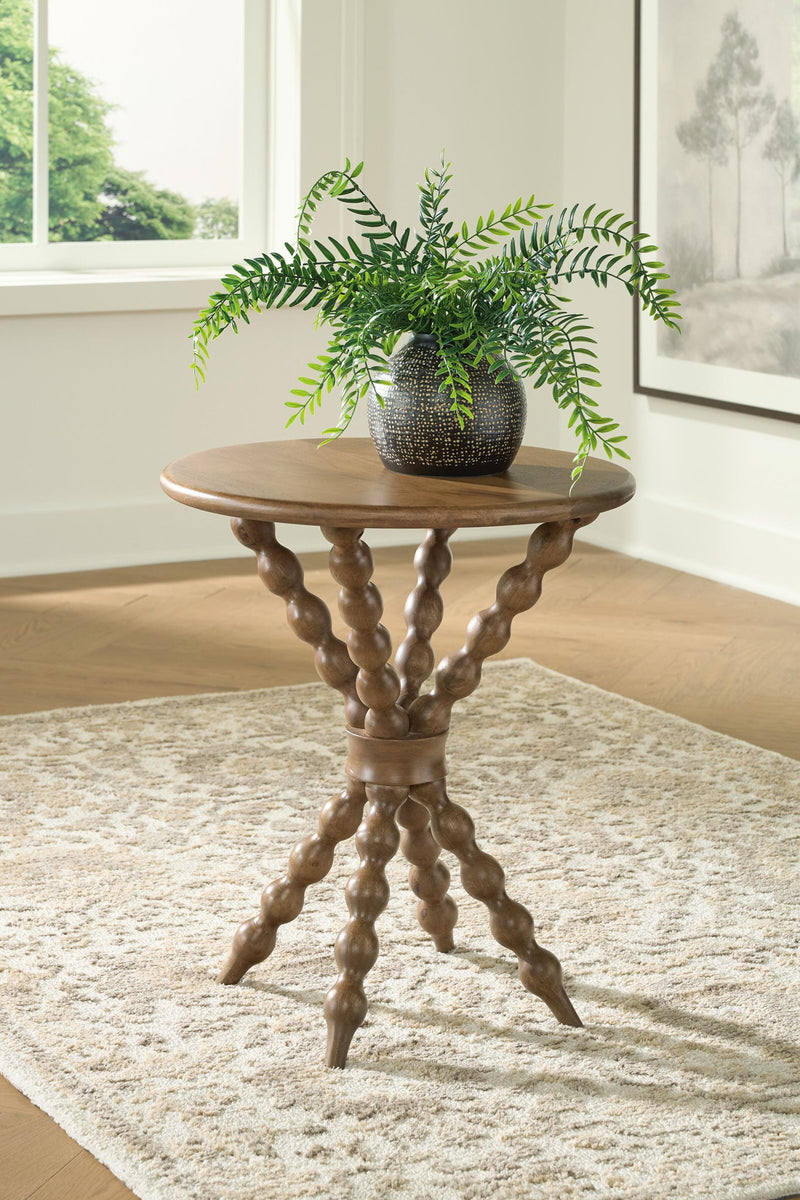 Light brown round accent table with curved trestle legs