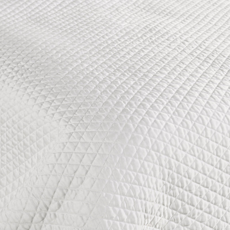 Quilted fabric sham panel in white with raised diamond texture pattern