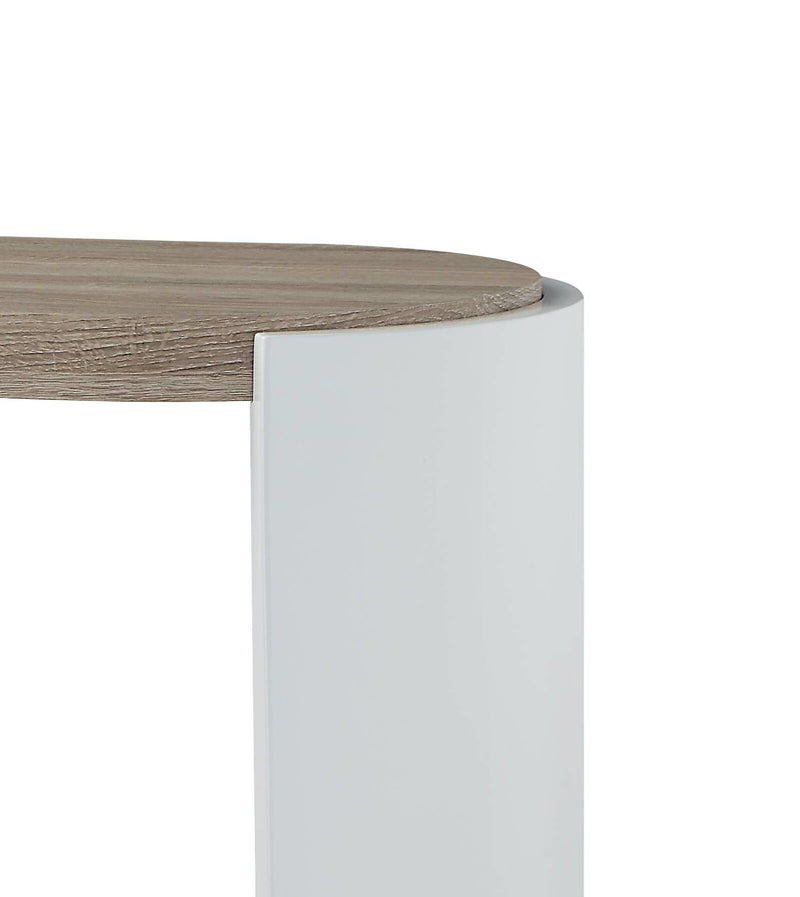 Corner detail of oak tabletop on white post-style base of sofa table