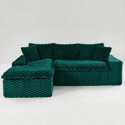 Dark green modular sofa with chaise lounge, textured woven upholstery and padded armrests