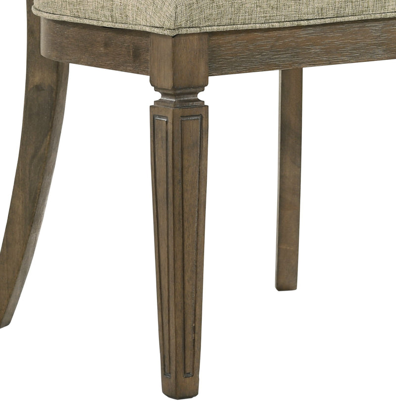 Upholstered dining chair seat with light brown oak legs and apron detail