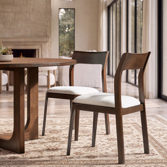 Wood dining chair with curved back and light beige seat cushion