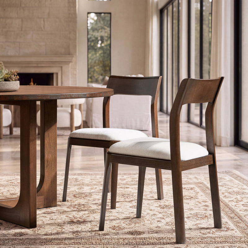 Wood dining chair with curved back and light beige seat cushion