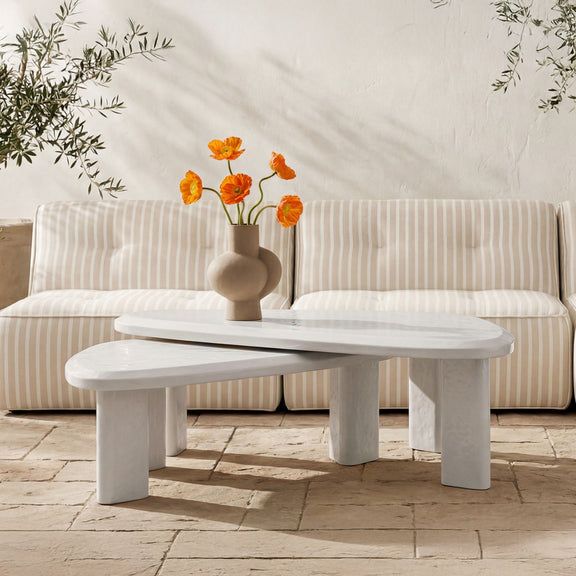 Outdoor nesting table set with whitewashed cream oval top and supporting legs