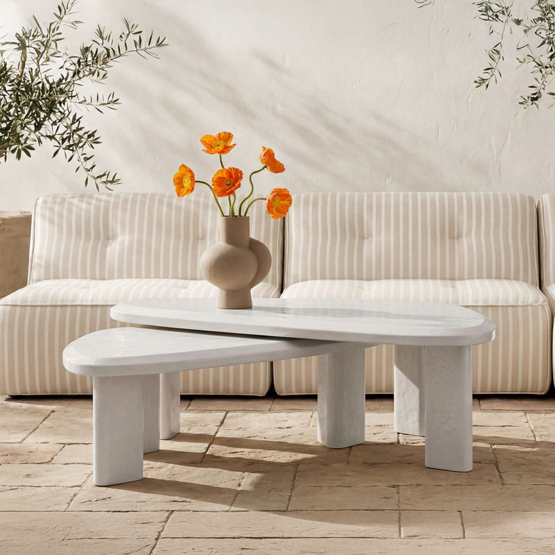 Outdoor nesting table set with whitewashed cream oval top and supporting legs