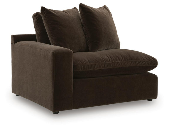 Dark brown sectional chaise with two throw pillows and low arm cushions.