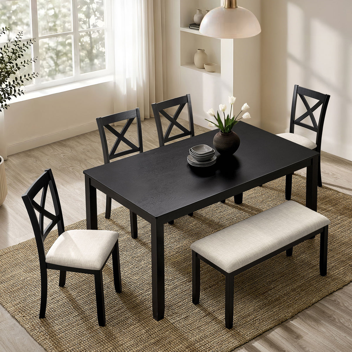 Rectangular dining table with four chairs, dark tabletop and light upholstered seats