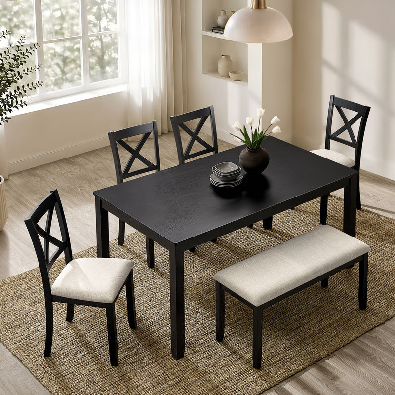 Rectangular dining table with four chairs, dark tabletop and light upholstered seats